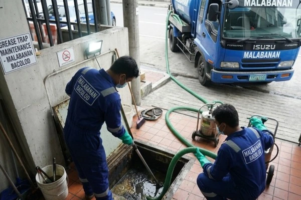 Malabanan Bacolod workers performing grease trap maintenance and deep-cleaning at a SM Super market restaurant.