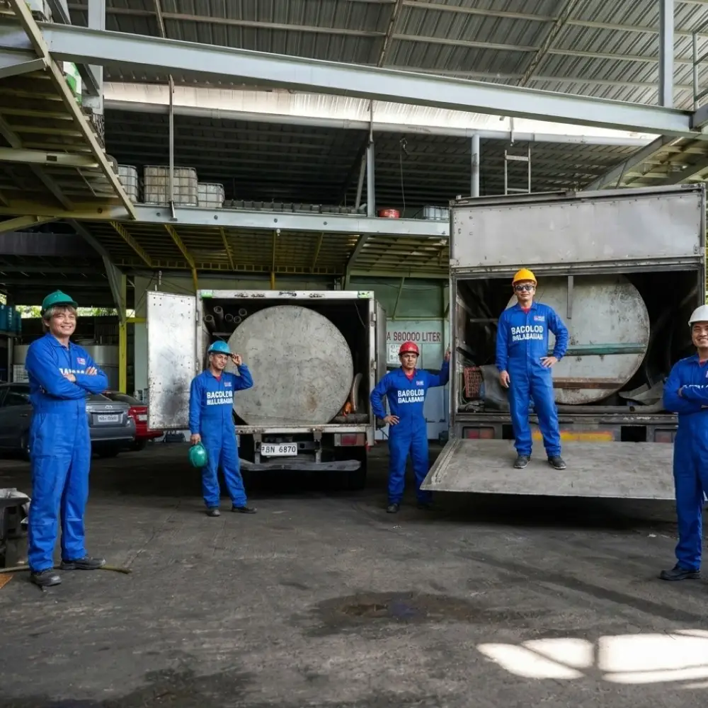 The Malabanan Bacolod service team based in Sum-ag, Negros Occidental, posing with their heavy-duty waste transport vehicles. This image highlights the company's professional staff and technical capacity for large-scale STP cleaning, factory waste pumping, and siphoning services across the region.